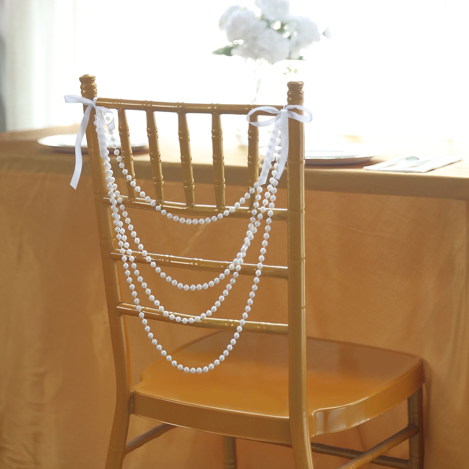 White faux pearl beaded chair back garland for weddings.