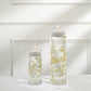 Gold vase filler with floating candles for elegant table decor.