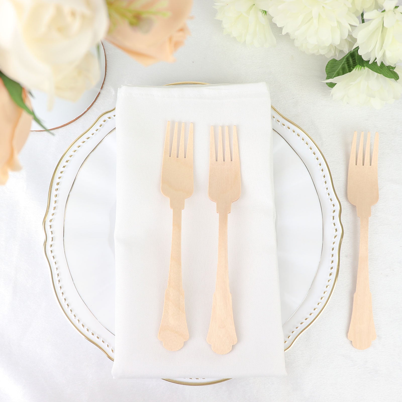 Vintage Baroque design disposable wooden forks on a white plate.