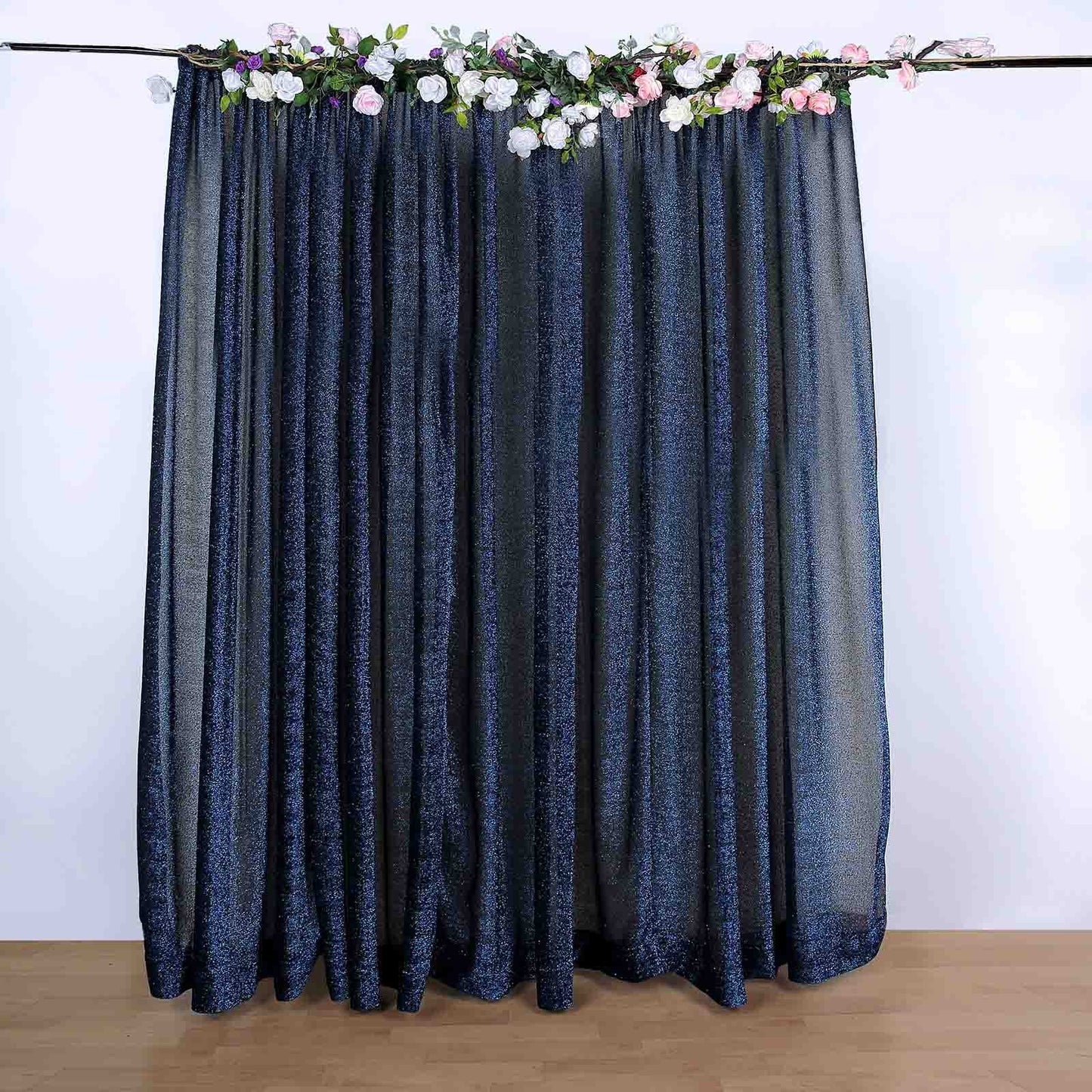 Navy blue metallic shimmer tinsel event curtain drapes with floral accents.