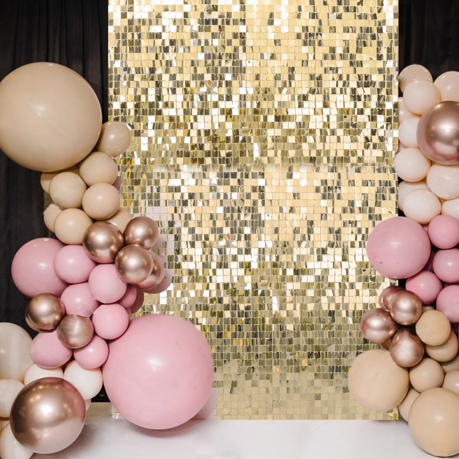Ritzy gold square sequin wall party backdrop with balloon decor.