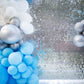 Ritzy silver sequin backdrop with blue and silver balloon accents.