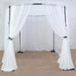 Black metal circular wedding arch stand with sheer white drapes.