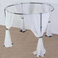 Black metal circular wedding arch stand with white drapes.
