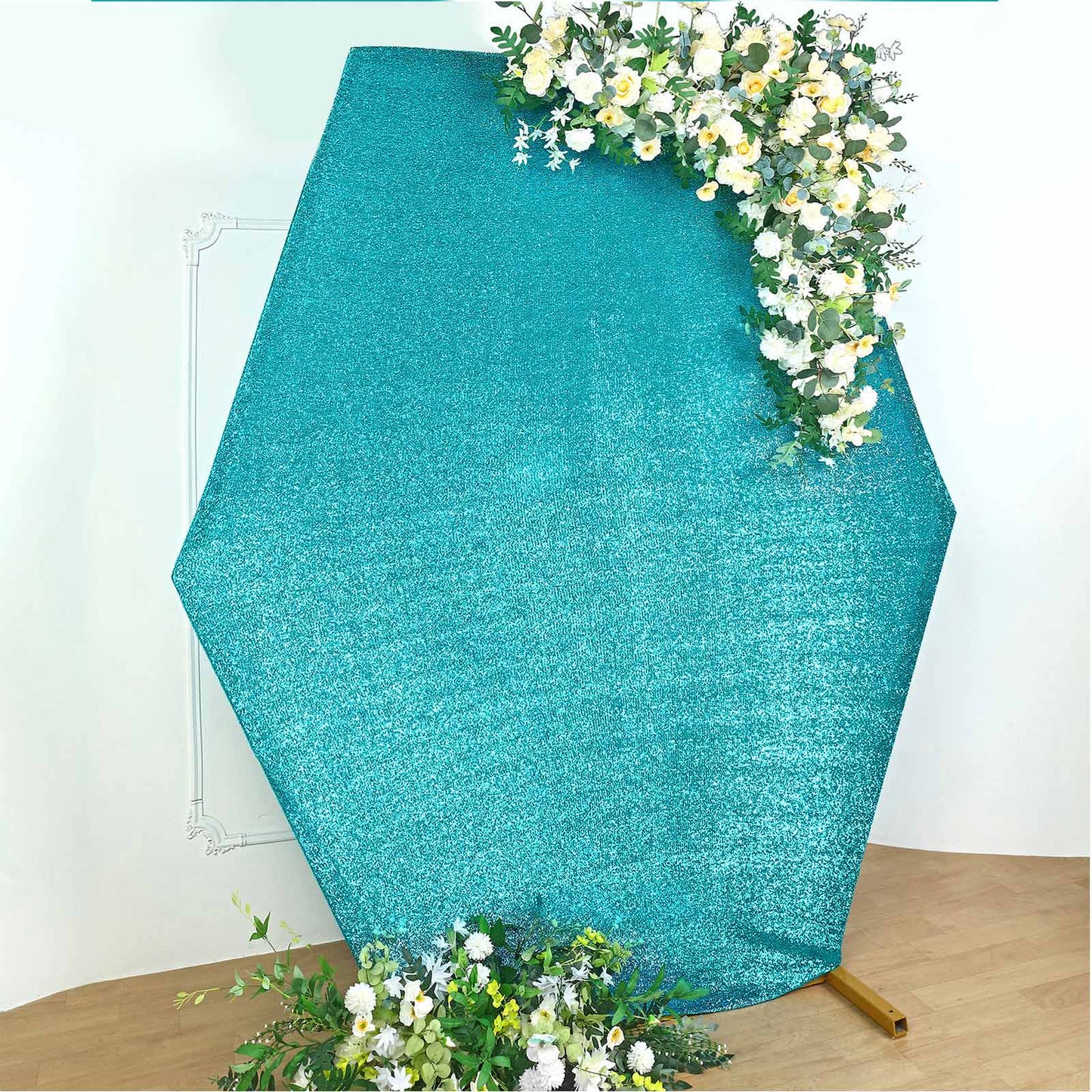 Turquoise metallic shimmer hexagon backdrop with floral accents.
