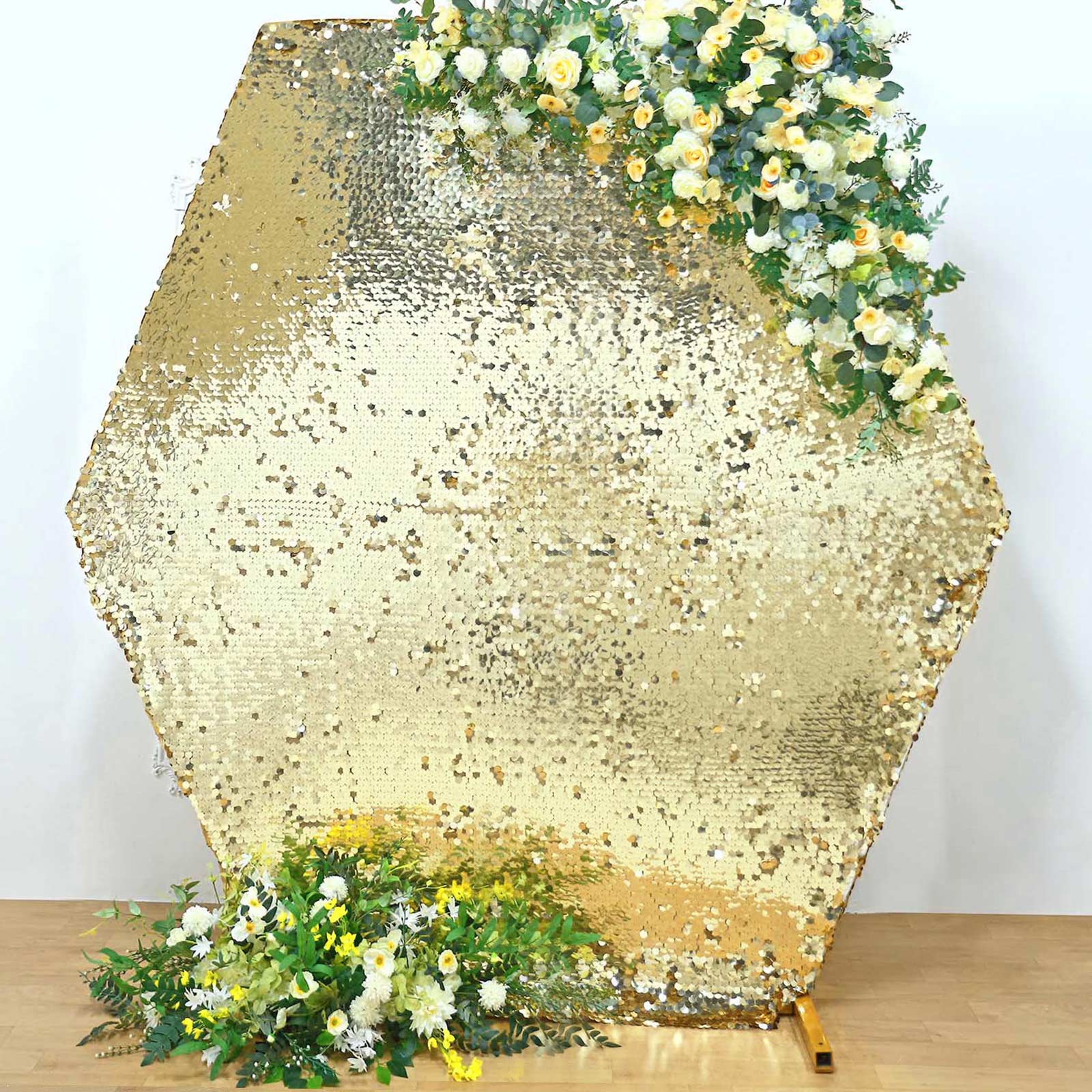 Champagne sequin hexagon wedding arch cover with floral accents.