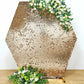Gold sequin hexagon wedding arch cover with floral accents.