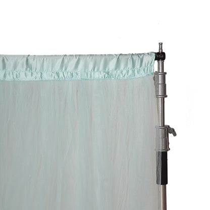 Light blue sheer tulle event curtain drapes with satin header.