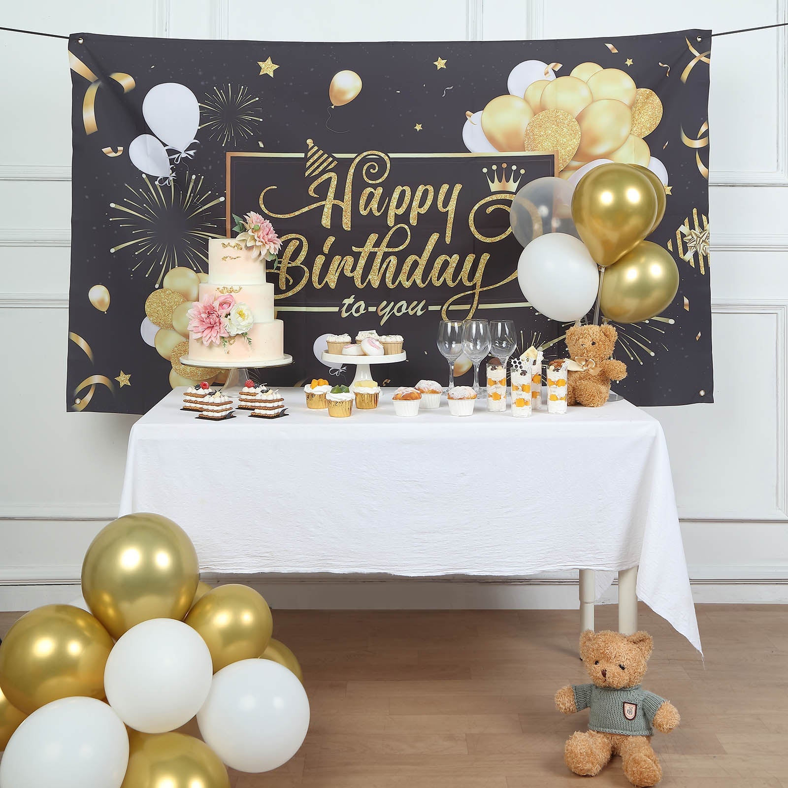 Black and gold Happy Birthday banner backdrop for celebrations.