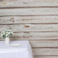 Rustic white washed wood panel photography backdrop with floral arrangement.
