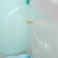 Mint green balloon arch kit with decorating strips and balloon tie tool.