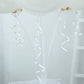 White balloon arch kit with curling ribbons for party decorations.