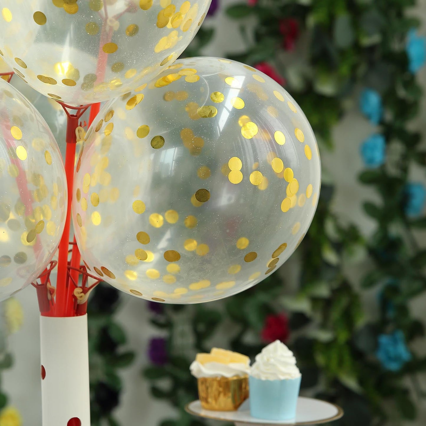 Clear and gold confetti-filled balloons on a festive display.