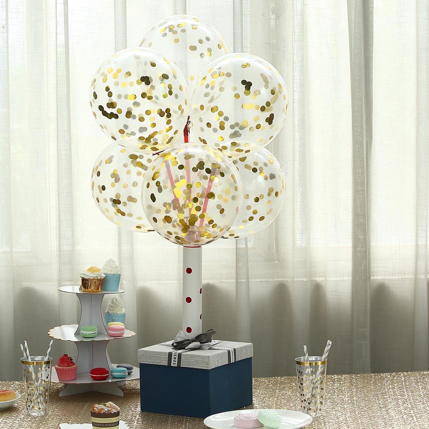 Clear and gold confetti filled balloons in a festive arrangement.