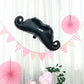 31" black mustache shaped mylar balloon for party decorations.