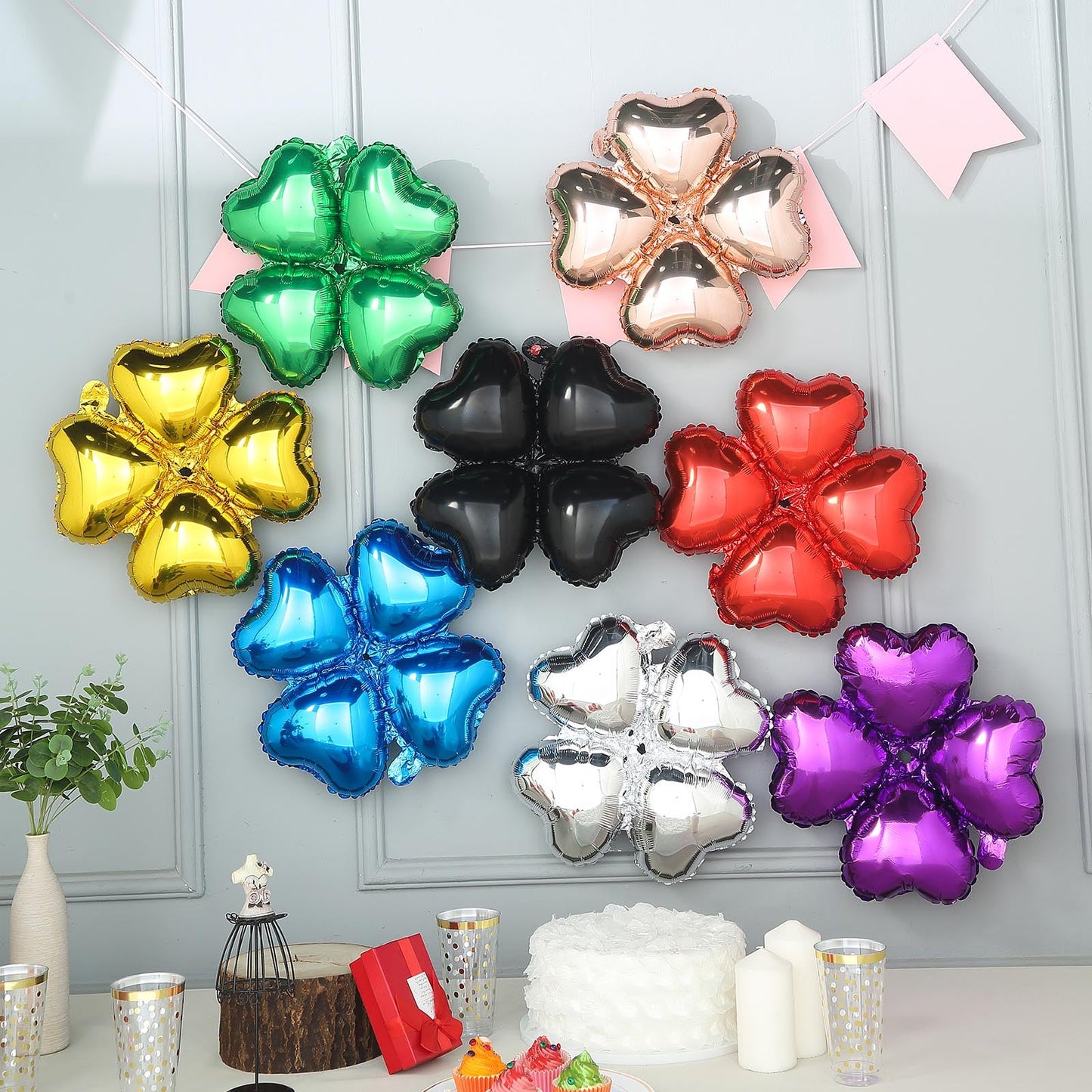 Shiny green four leaf clover shaped mylar foil balloons on display.