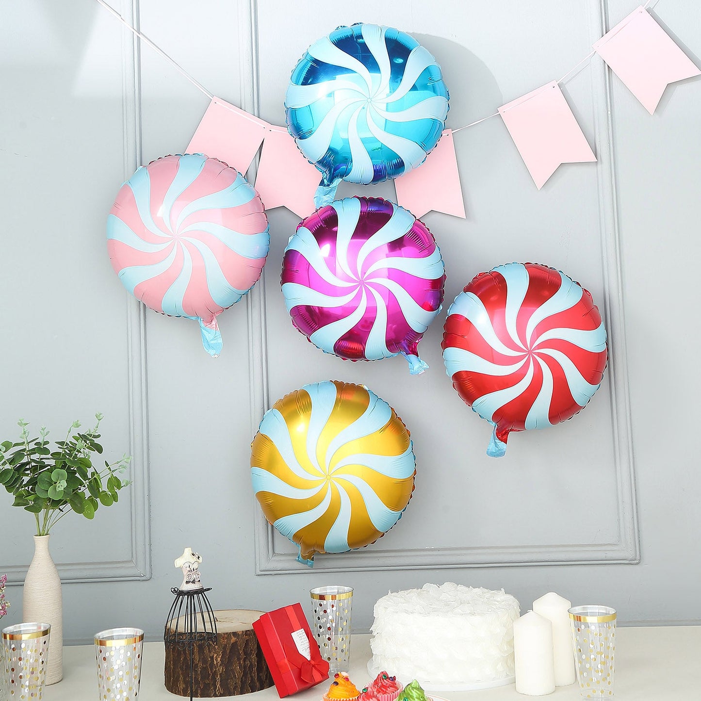 Colorful candy striped swirl print mylar foil balloons.