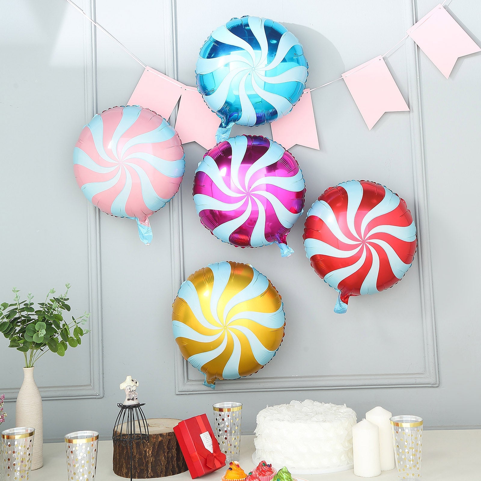 Colorful candy striped swirl print mylar foil balloons.