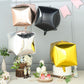 Rose gold cube-shaped mylar foil helium balloons.