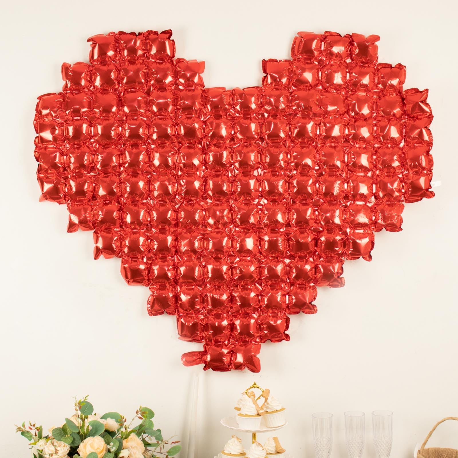 Metallic red heart-shaped mylar foil balloon backdrop for events.