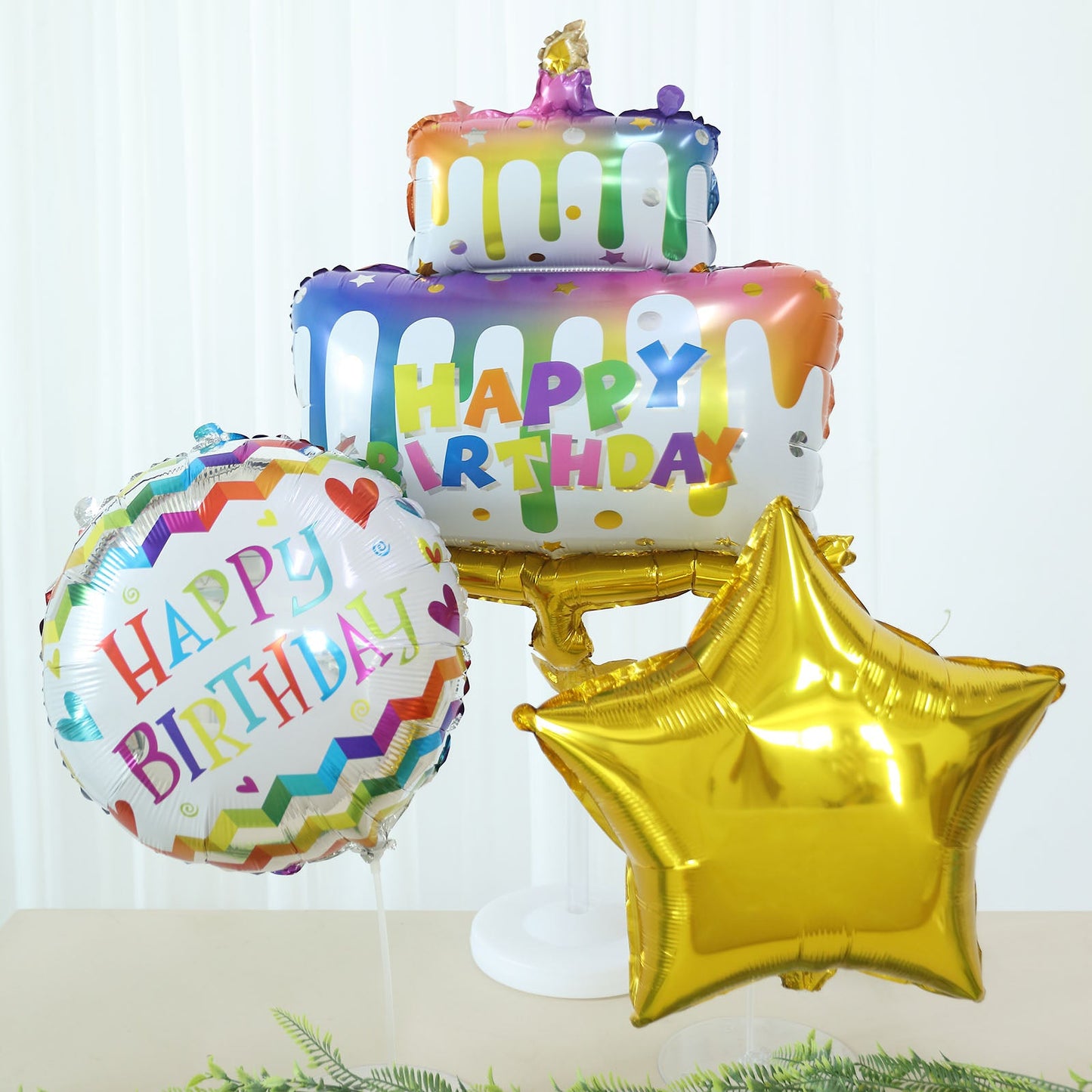 Colorful birthday balloon set with a gold star and cake design.
