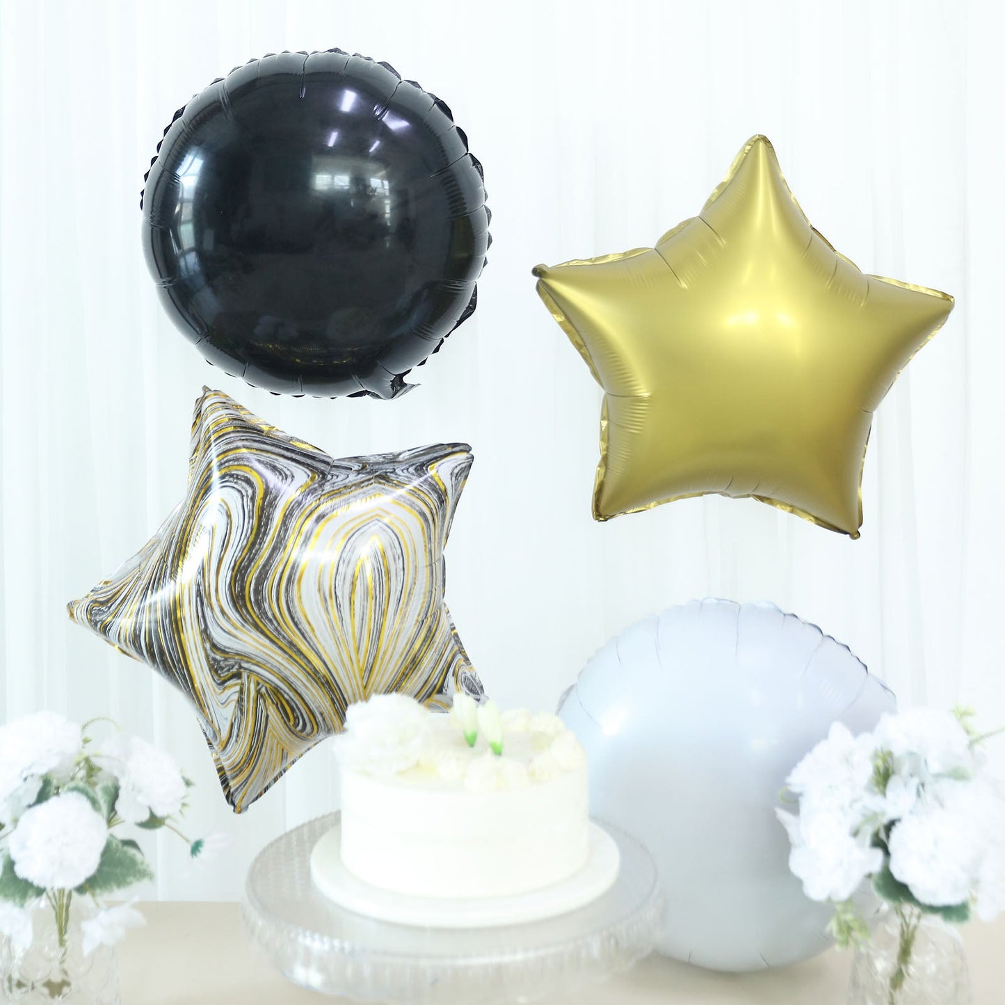 Gold and black marble foil party balloon set with star and round shapes.