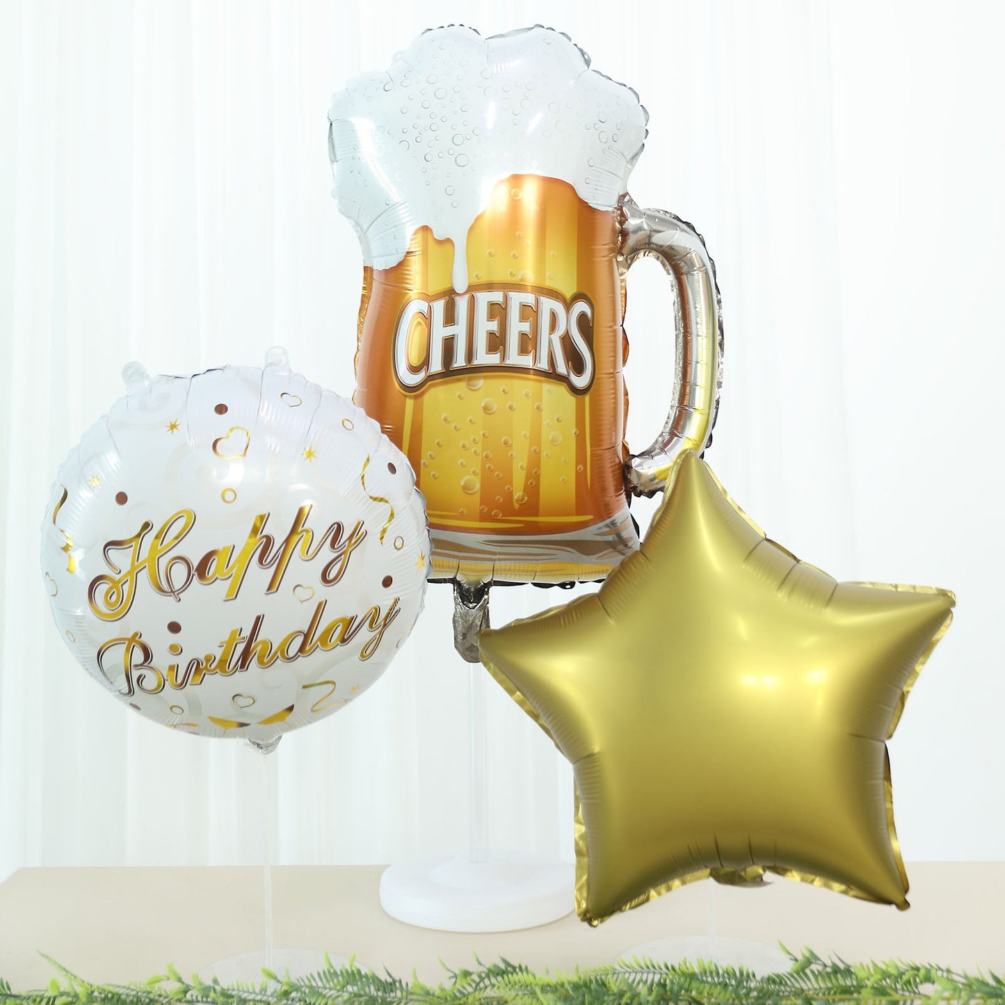 White and gold balloon set with Cheers beer mug and star for birthday party decorations.