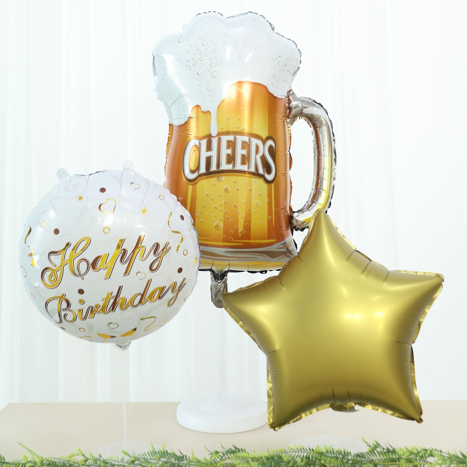 White and gold balloon set with Cheers beer mug and star for birthday party decorations.