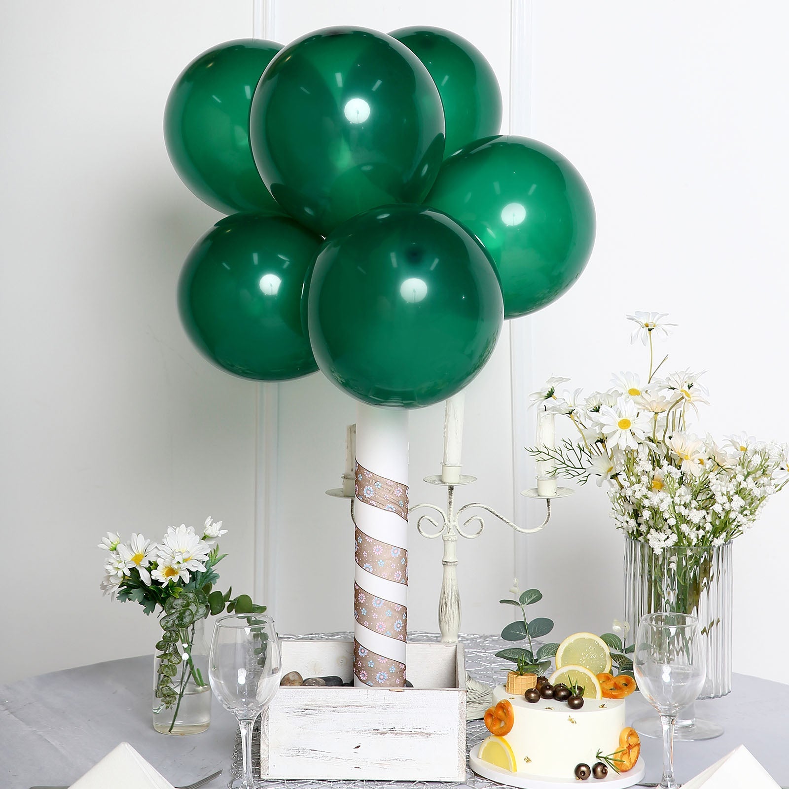 Matte pastel emerald party balloons arranged in a decorative display.