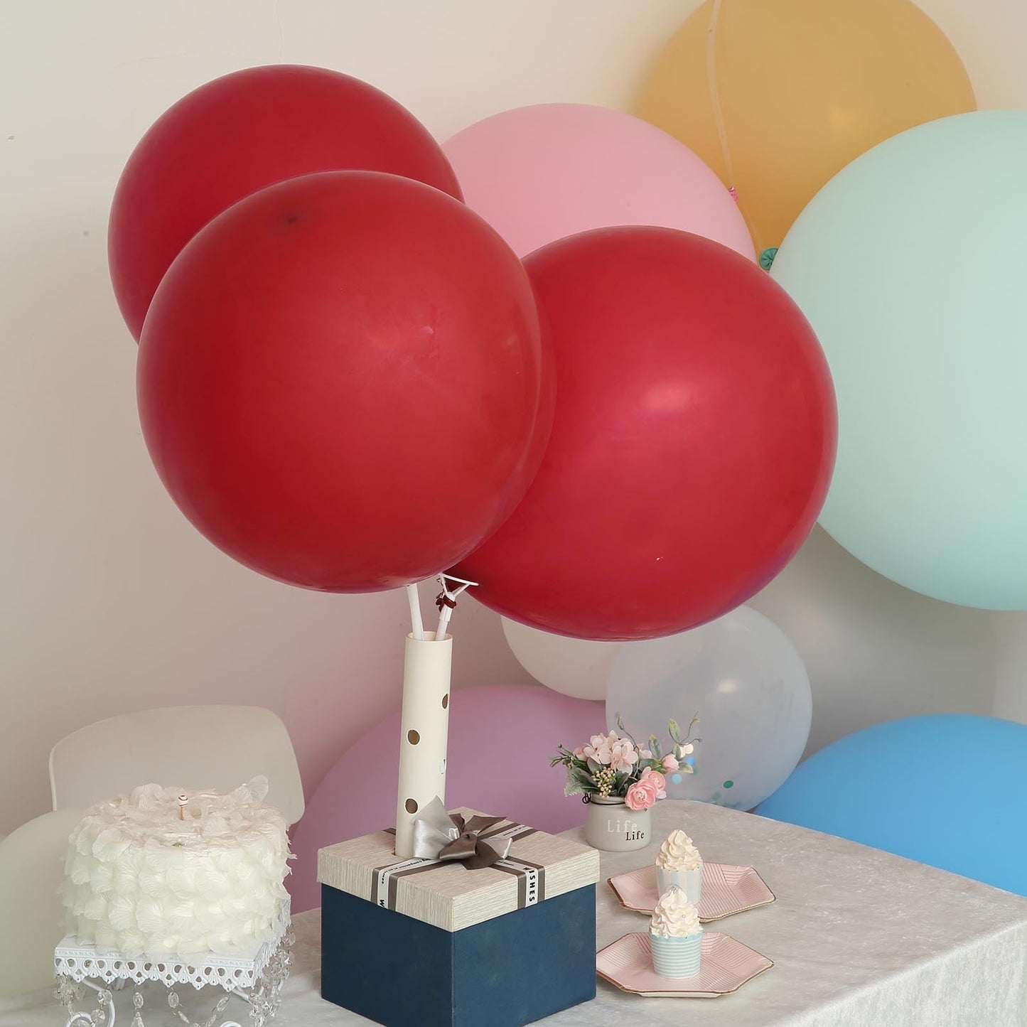 Matte pastel burgundy latex party balloons on a table setting.