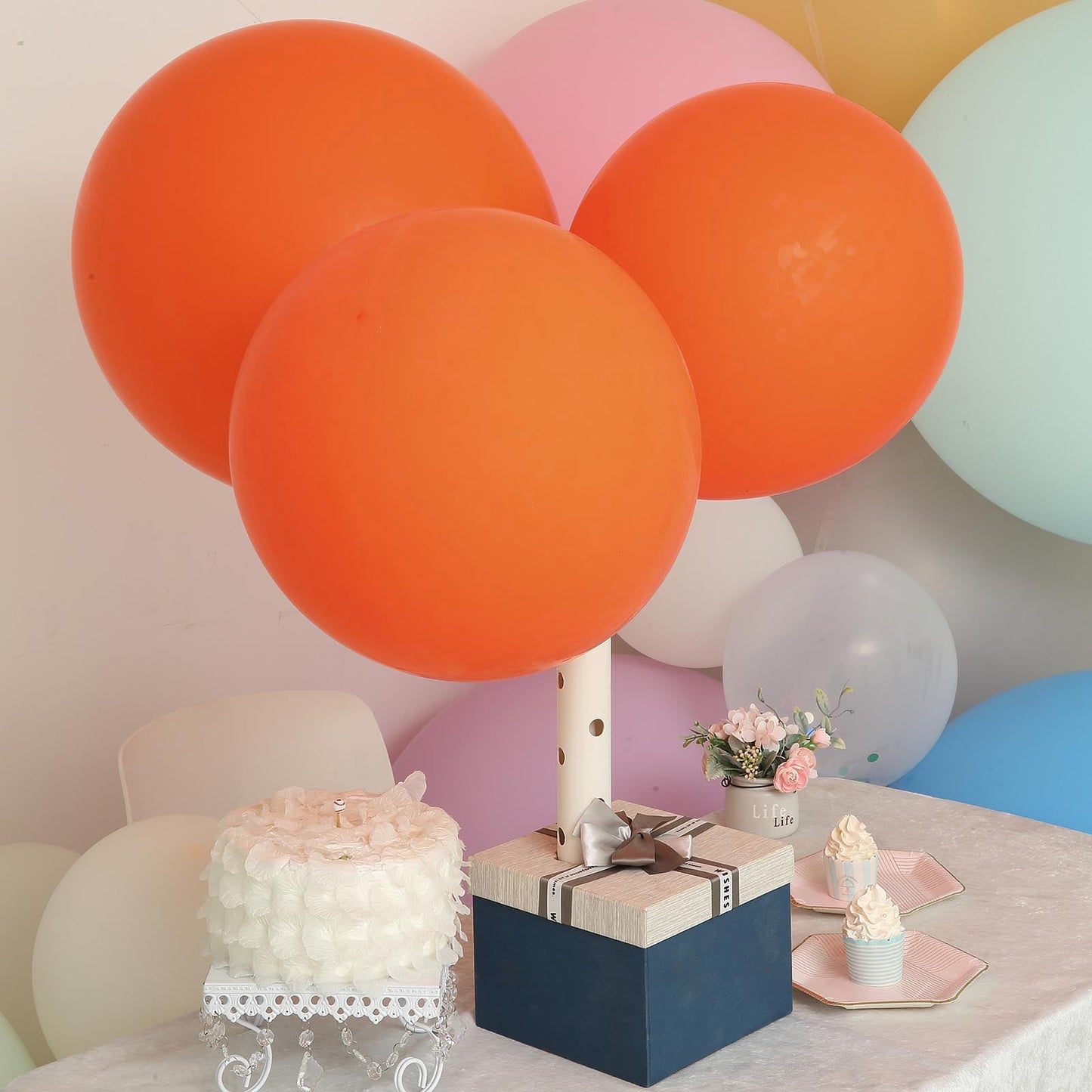 Matte pastel orange helium or air latex party balloons on a table.