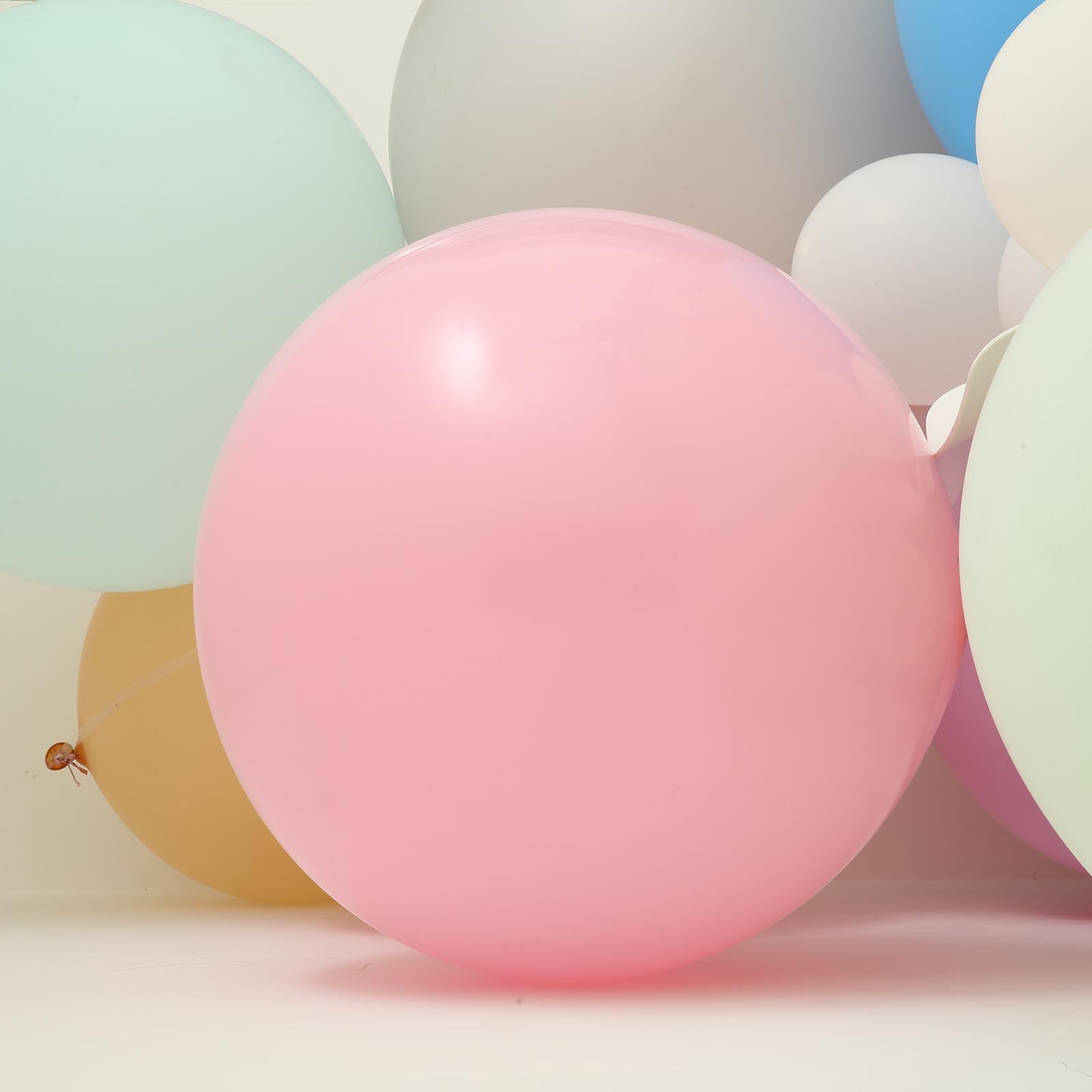 Large pastel blush latex balloons in a vibrant arrangement.