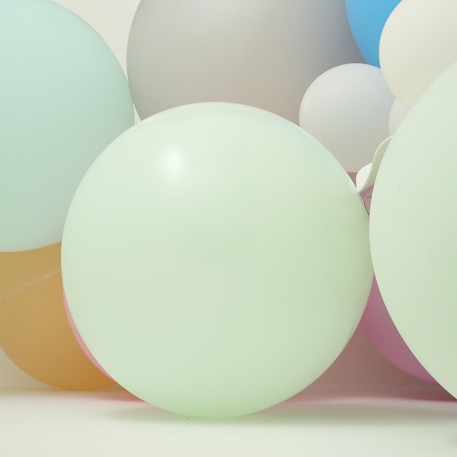Matte pastel mint balloons in a vibrant arrangement.