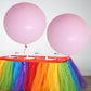 Large pastel pink helium balloons on a festive table.
