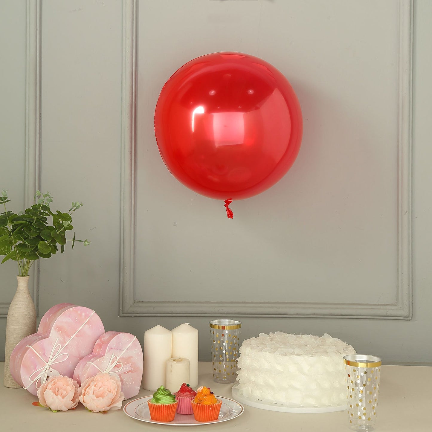 Shiny red reusable UV protected vinyl balloon, 18 inches, with celebratory decor.