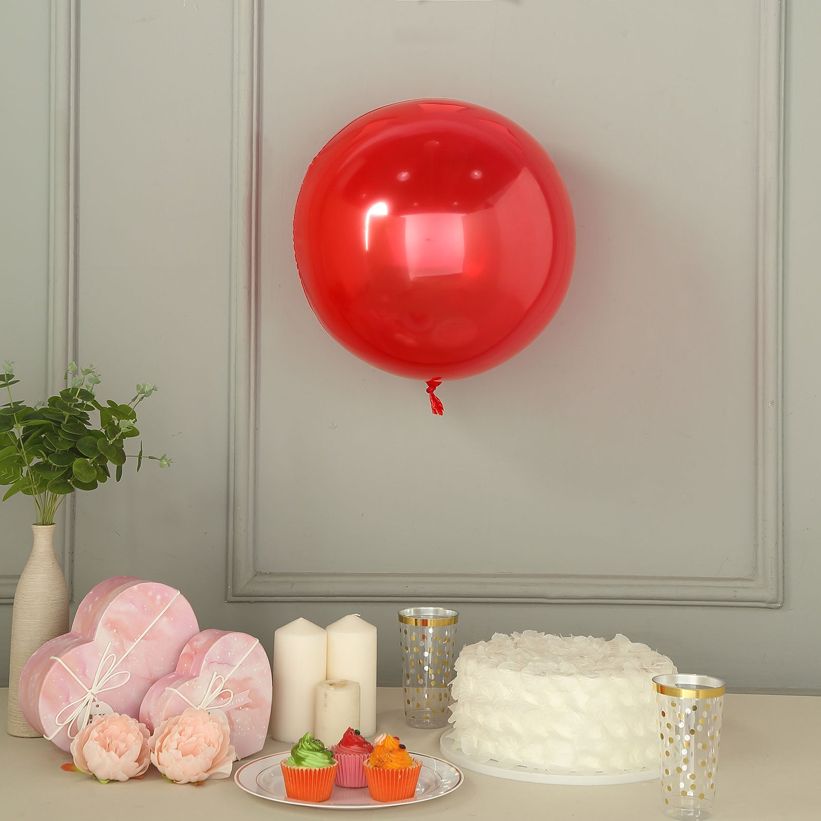 Shiny red reusable UV protected vinyl balloon, 18 inches, with celebratory decor.