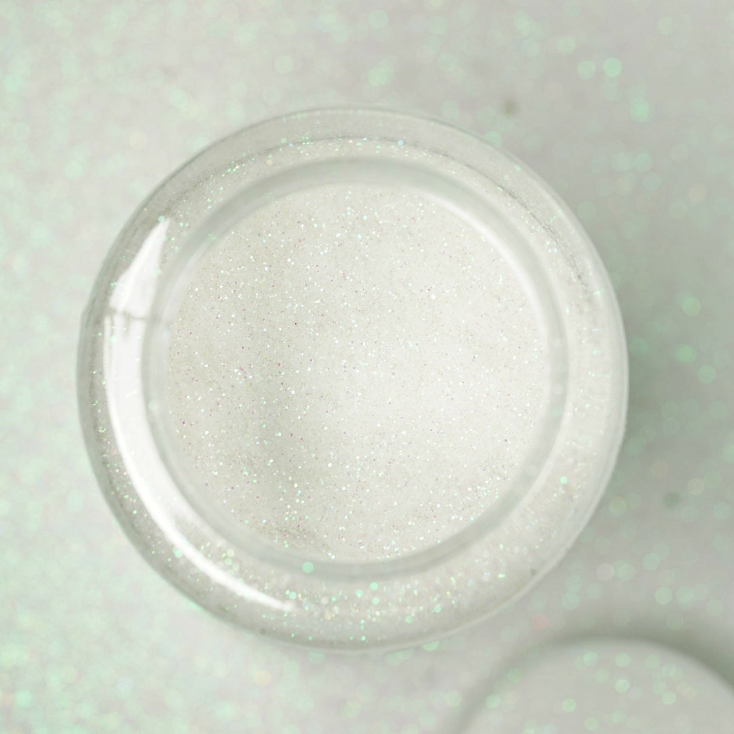 Nontoxic white extra fine glitter in a 1 lb bottle for arts and crafts.