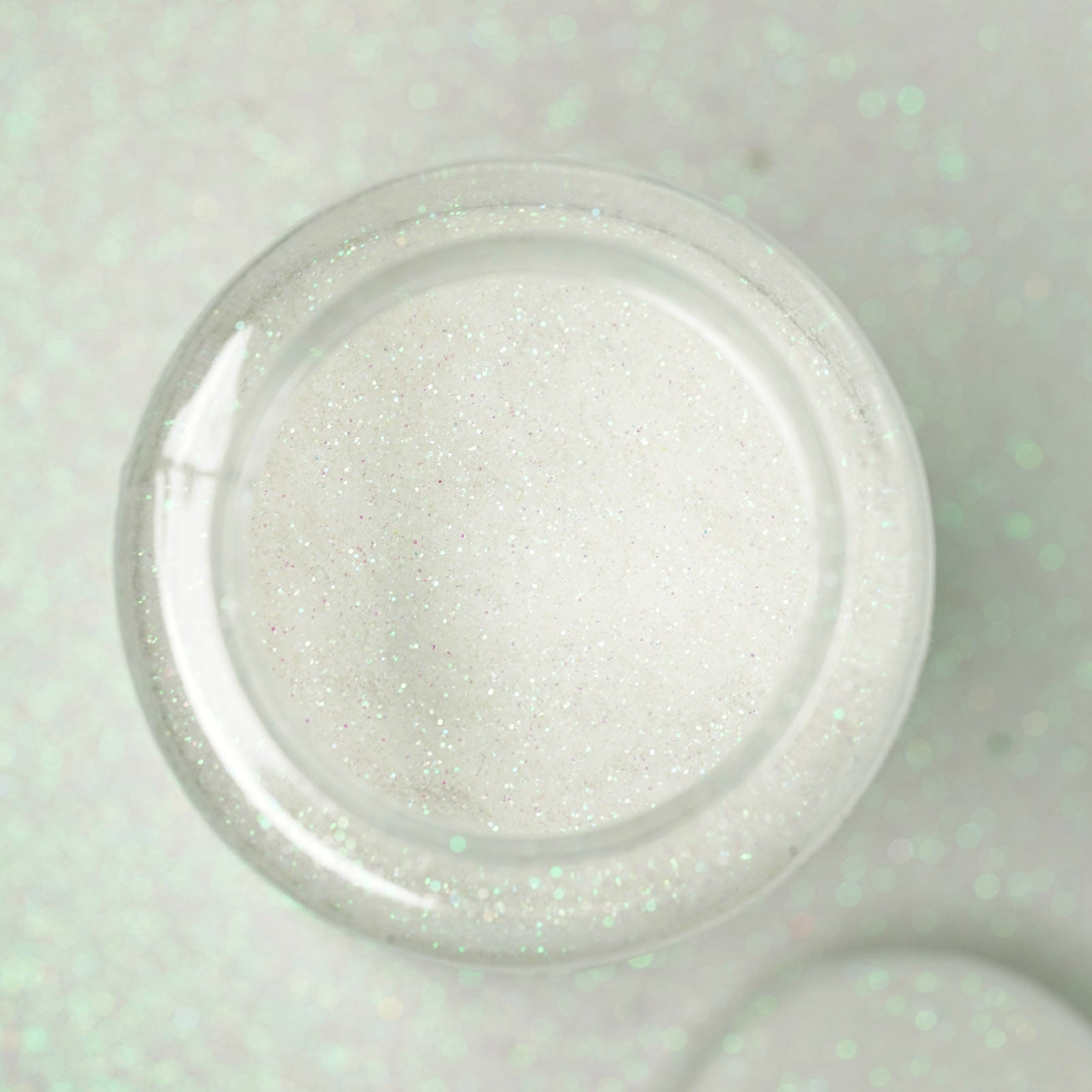 Nontoxic white extra fine glitter in a 1 lb bottle for arts and crafts.