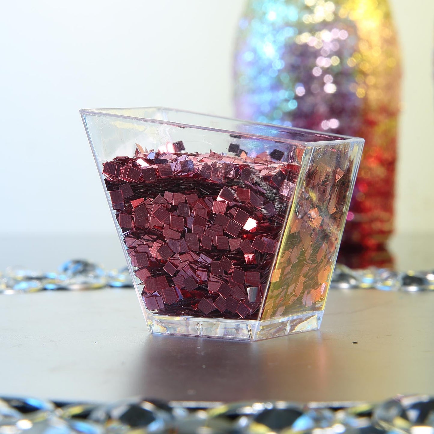 Metallic rose gold chunky confetti glitter in a clear container.