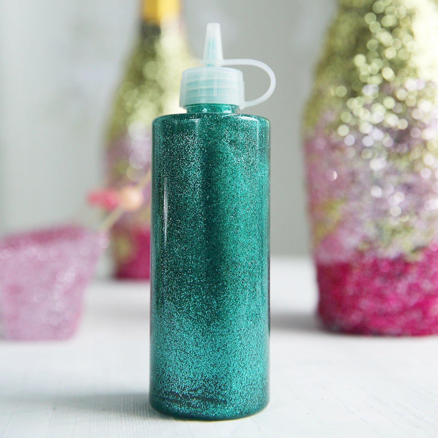 Metallic turquoise glitter glue for art and craft projects.