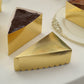 Metallic gold triangular cake boxes for dessert slices.