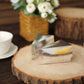 Silver triangular cake boxes with scalloped tops on a rustic wooden surface.