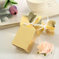 Gold floral satin ribbon gift boxes for party favors.