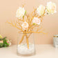 14" Metallic Gold Artificial Tree Branches in a vase with flowers.
