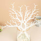 White artificial tree branches in a vase, perfect for DIY decor.