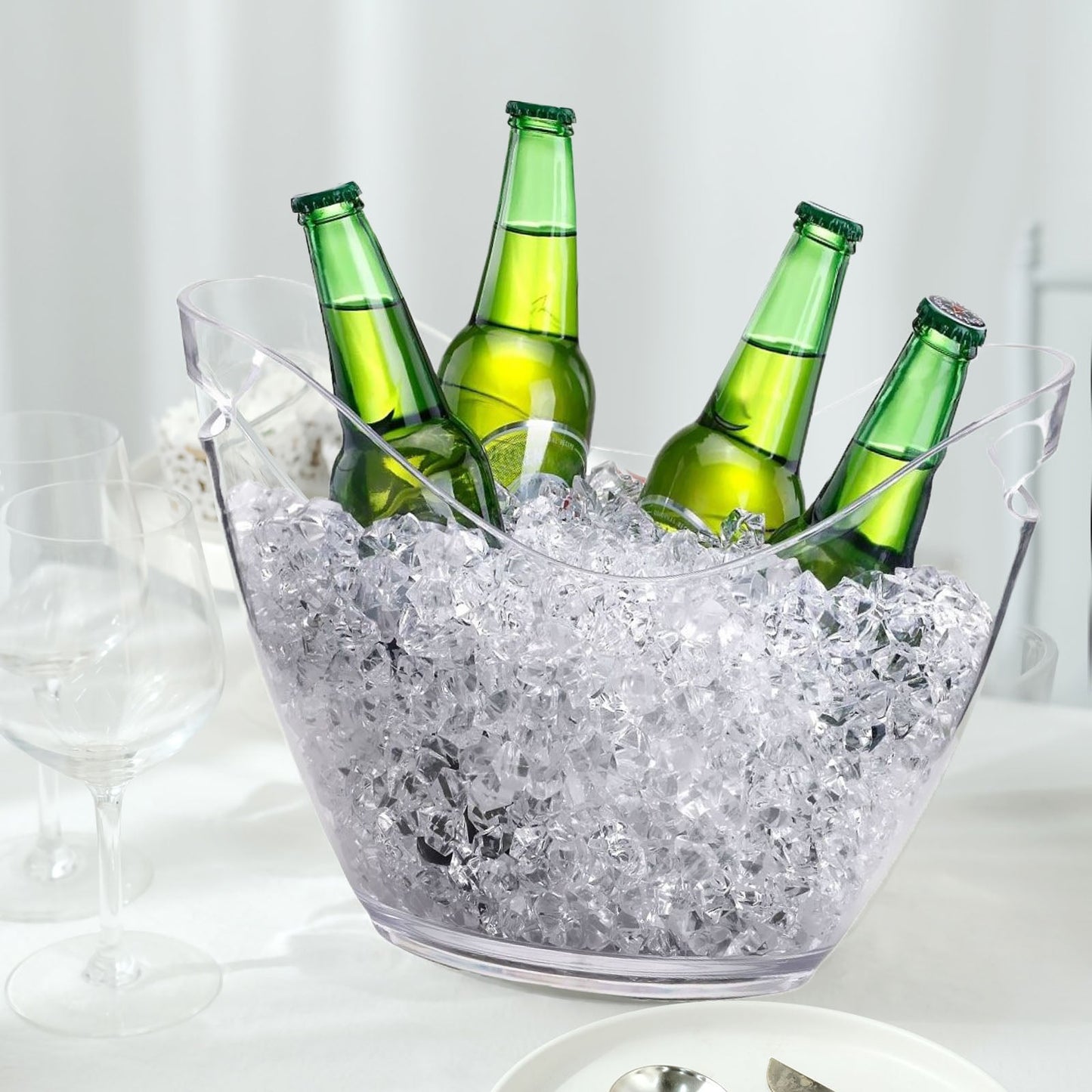 Clear plastic ice bucket with drinks, ideal for parties and outdoor events.