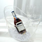 Clear plastic ice and drinks bucket with handles for party beverage storage.