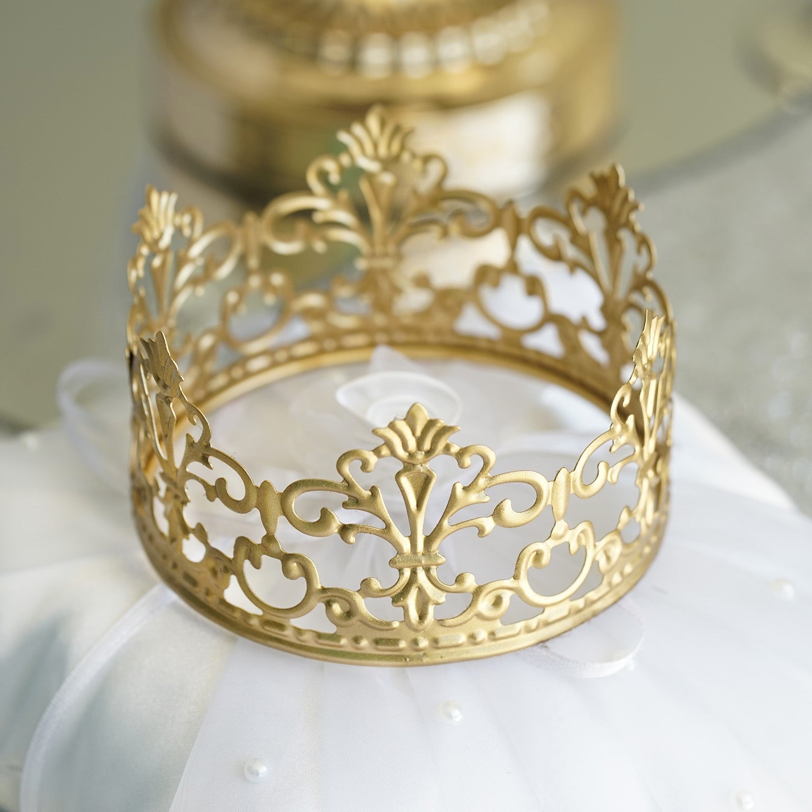Matte gold metal princess crown cake topper for wedding decor.