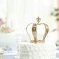 Gold metal crown cake topper with fleur-de-lis design.