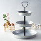 Galvanized metal 3-tier serving tray with rustic design for desserts and cupcakes.